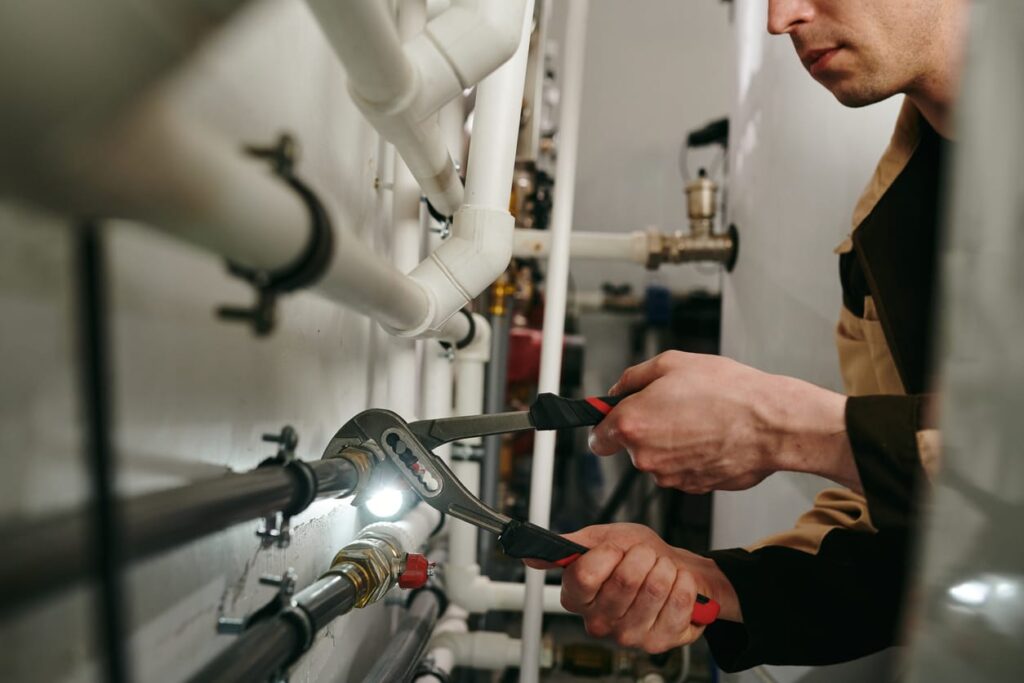 Plumbers maintaining commercial plumbing pipes in Bloomington