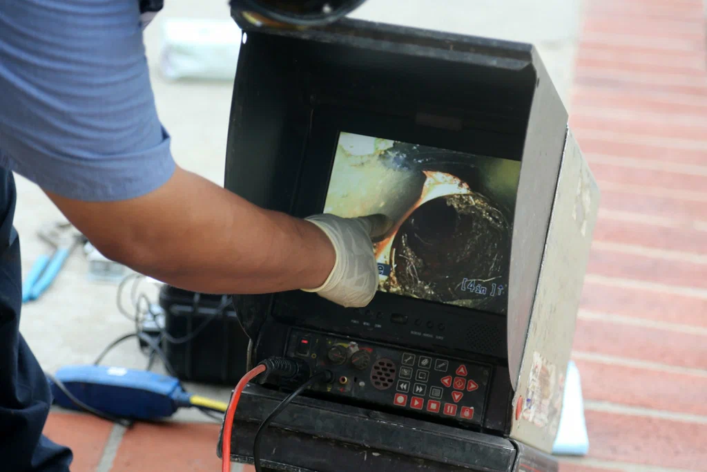 Technician viewing a drain inspection camera in Bloomington